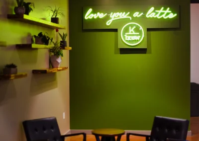 Inside of K Brew on Ebenezer, shows green wall with sign that says "love you a latte"